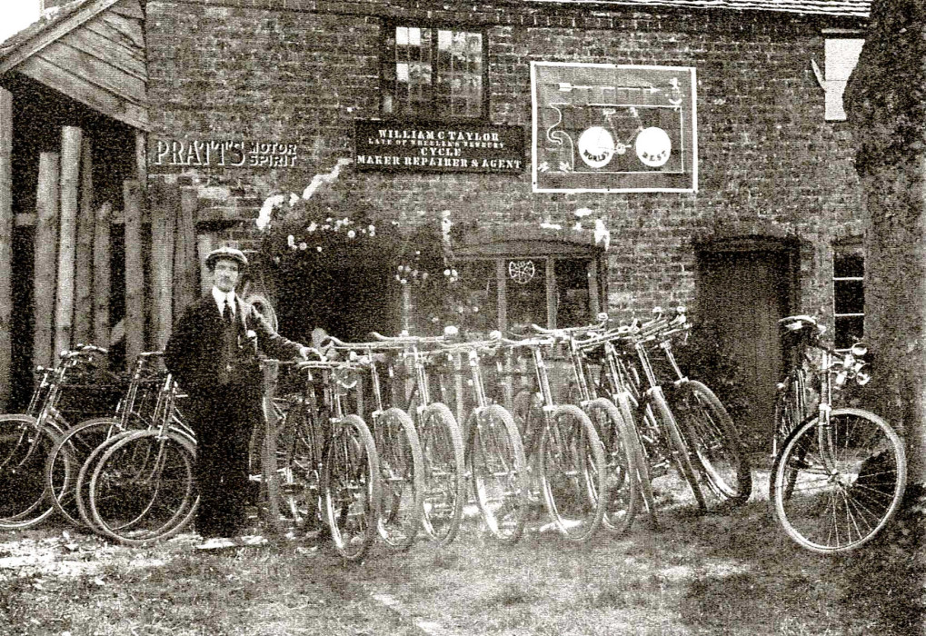 A man stands alongside several bicycles ref. D/EX2745/3/1