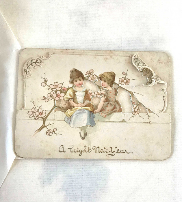 Nineteenth century greetings card showing two girls with the words A Bright New Year 